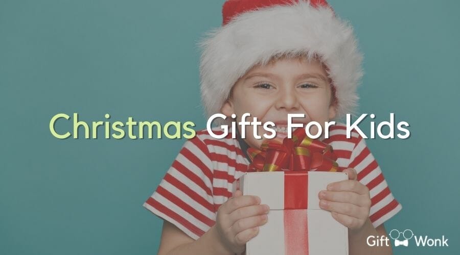 christmas gift ideas for kids and a smiling little boy holding a Christmas present
